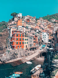 High angle view of buildings by sea against clear sky