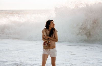 Brunette woman at the sea on sunset