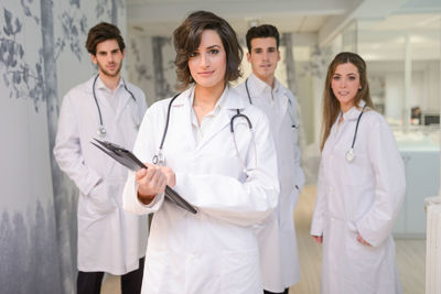 Portrait of confident doctors standing in lobby