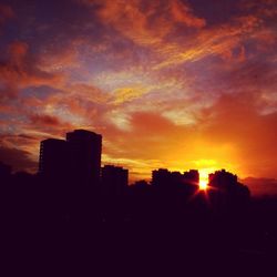 Silhouette of buildings against dramatic sky