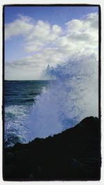 Scenic view of sea against cloudy sky