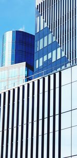 Low angle view of modern building against blue sky