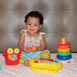 Portrait of cute girl playing with toy at home