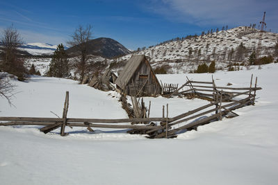 Snow covered field against sky