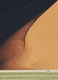 Scenic view of desert against sky during sunset