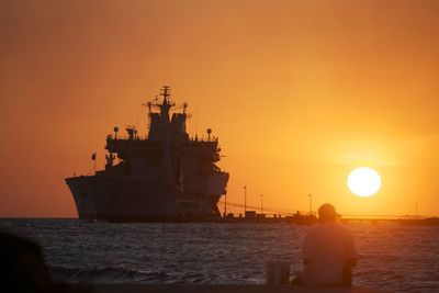 Scenic view of sea against orange sky