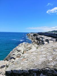 Scenic view of beach against blue sky