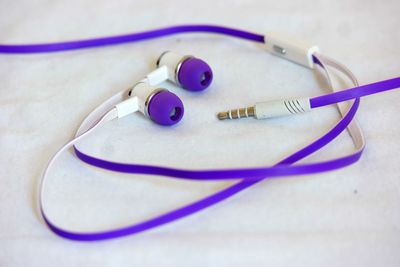 Close-up of earphones on white fabric