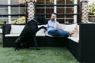 Woman with dog sitting outdoors