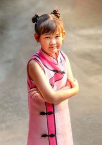 Portrait of cute girl standing on land