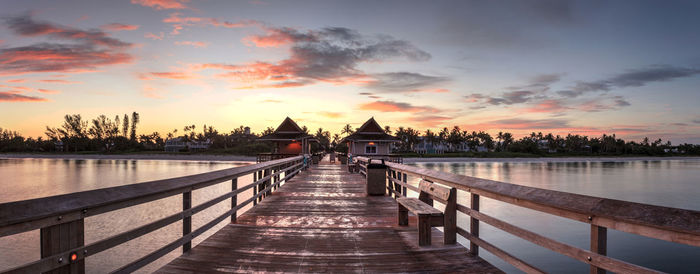 Bridge over lake against sky during sunset