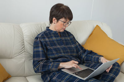 Young man using laptop at home