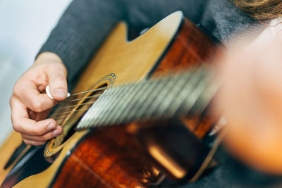 Detail shot of hands playing the guitar