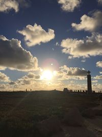 Scenic view of field against sky at sunset