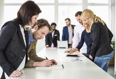 Multi-ethnic group of business people working at desk in office