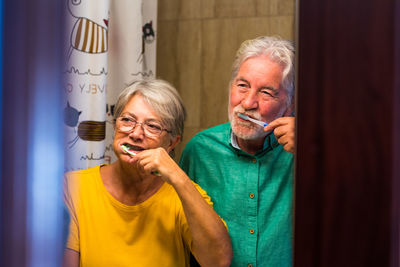 Young man and woman standing in bathroom