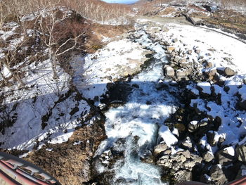 High angle view of frozen water on rock