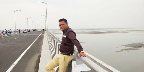 Full length of man standing on road against sky