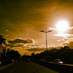Traffic on road at sunset