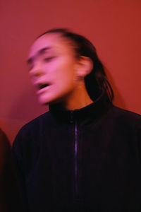 Close-up of young woman against gray background