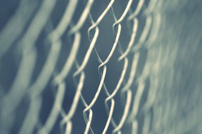 Full frame shot of fence against blue sky