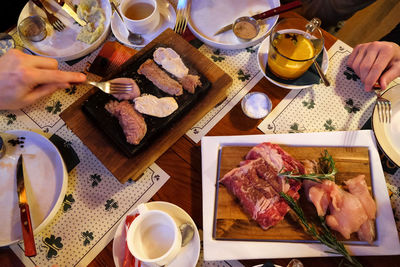 Top view of table in irish pub. meat grilled without oil on hot volcanic stone, original