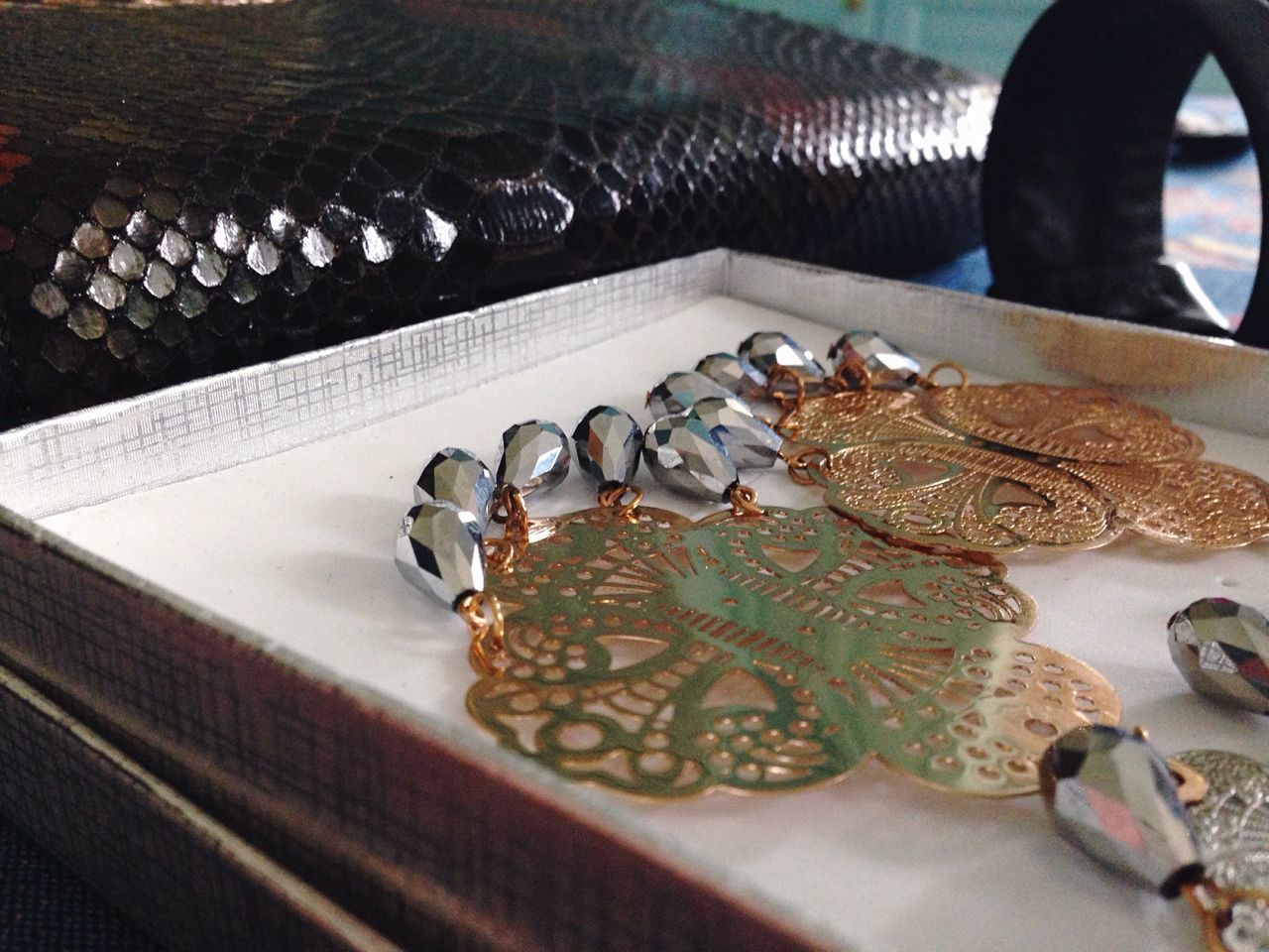 indoors, high angle view, close-up, table, metal, part of, selective focus, focus on foreground, pattern, day, metallic, large group of objects, still life, person, jewelry, cropped, connection, water