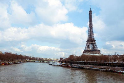 Ships in seine river with eiffel tower in background