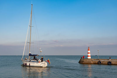 Sailboat on sea against sky