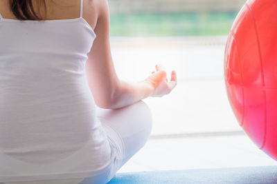 Low section of woman sitting outdoors
