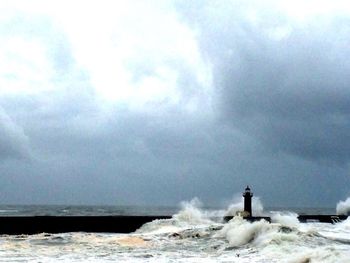 Scenic view of sea against cloudy sky