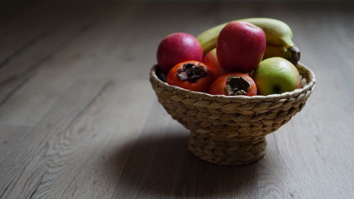 High angle view of fruits in basket on table