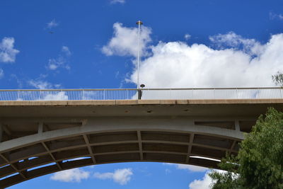 Low angle view of bridge against blue sky