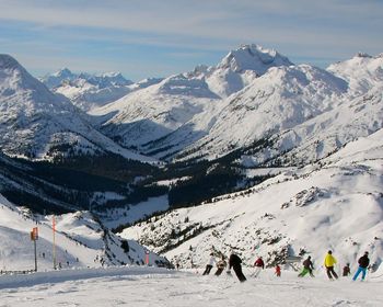 Tourists on snow covered mountain