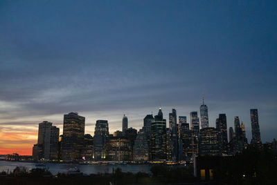 Illuminated cityscape against sky at night