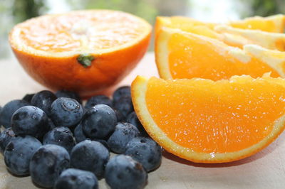 Close-up of orange slices with blueberries on table