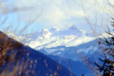 Scenic view of snowcapped mountains against sky