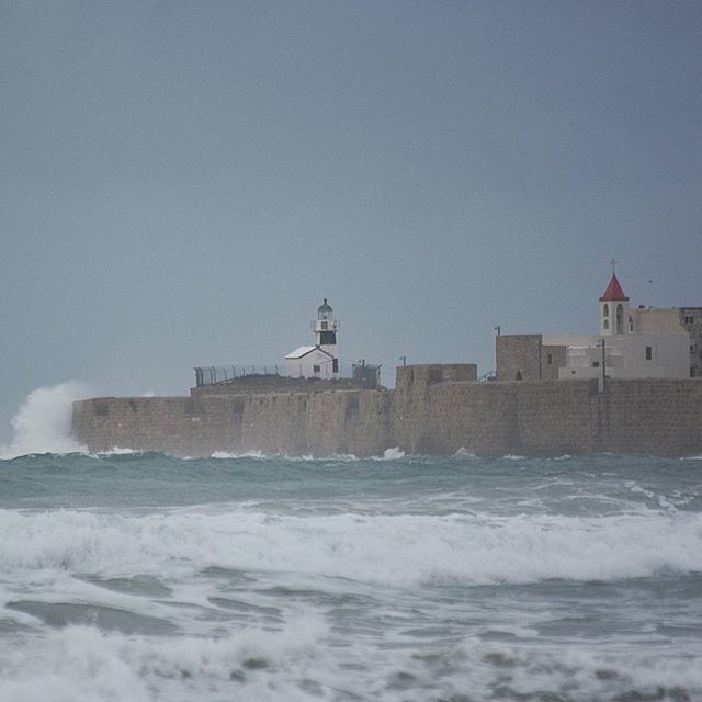 sea, water, building exterior, architecture, built structure, lighthouse, wave, waterfront, horizon over water, surf, copy space, guidance, clear sky, nature, sky, motion, day, scenics, outdoors, direction