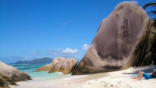 Scenic view of beach against clear blue sky