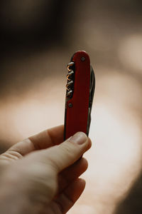 Close-up of person holding penknife