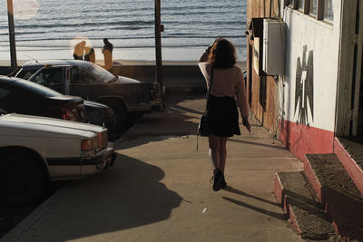 Rear view of woman on road in city