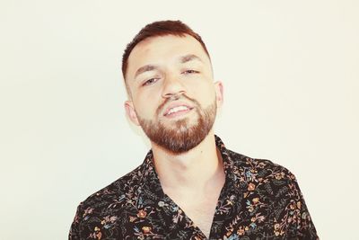 Portrait of young man against white background