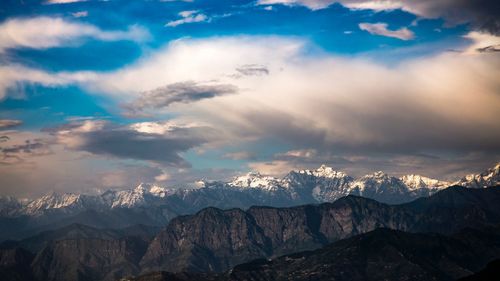 Scenic view of mountains against cloudy sky