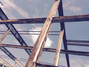 Low angle view of bridge against cloudy sky