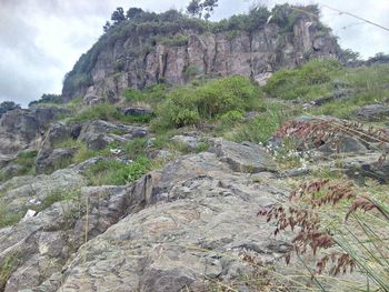 Rock formations on landscape against sky