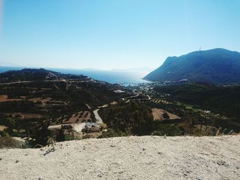 Panoramic shot of countryside landscape against clear blue sky