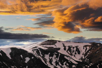 Scenic view of snow mountains against sky during sunset