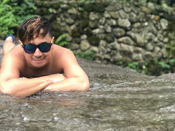 Portrait of shirtless man in water