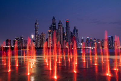 Panoramic view of illuminated buildings against sky at night