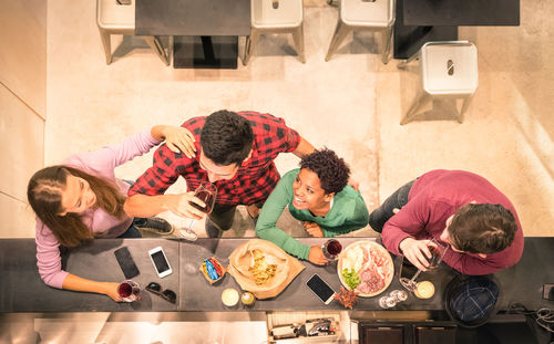 High angle view of friends having food at restaurant